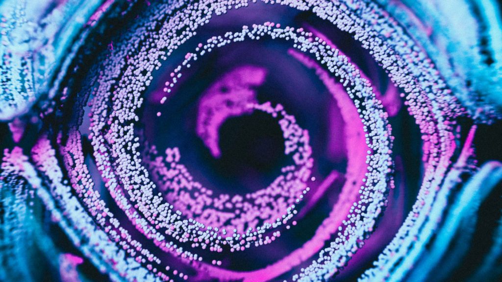 Abstract digital image of streaks of particles in light blue and purple moving in a spiral